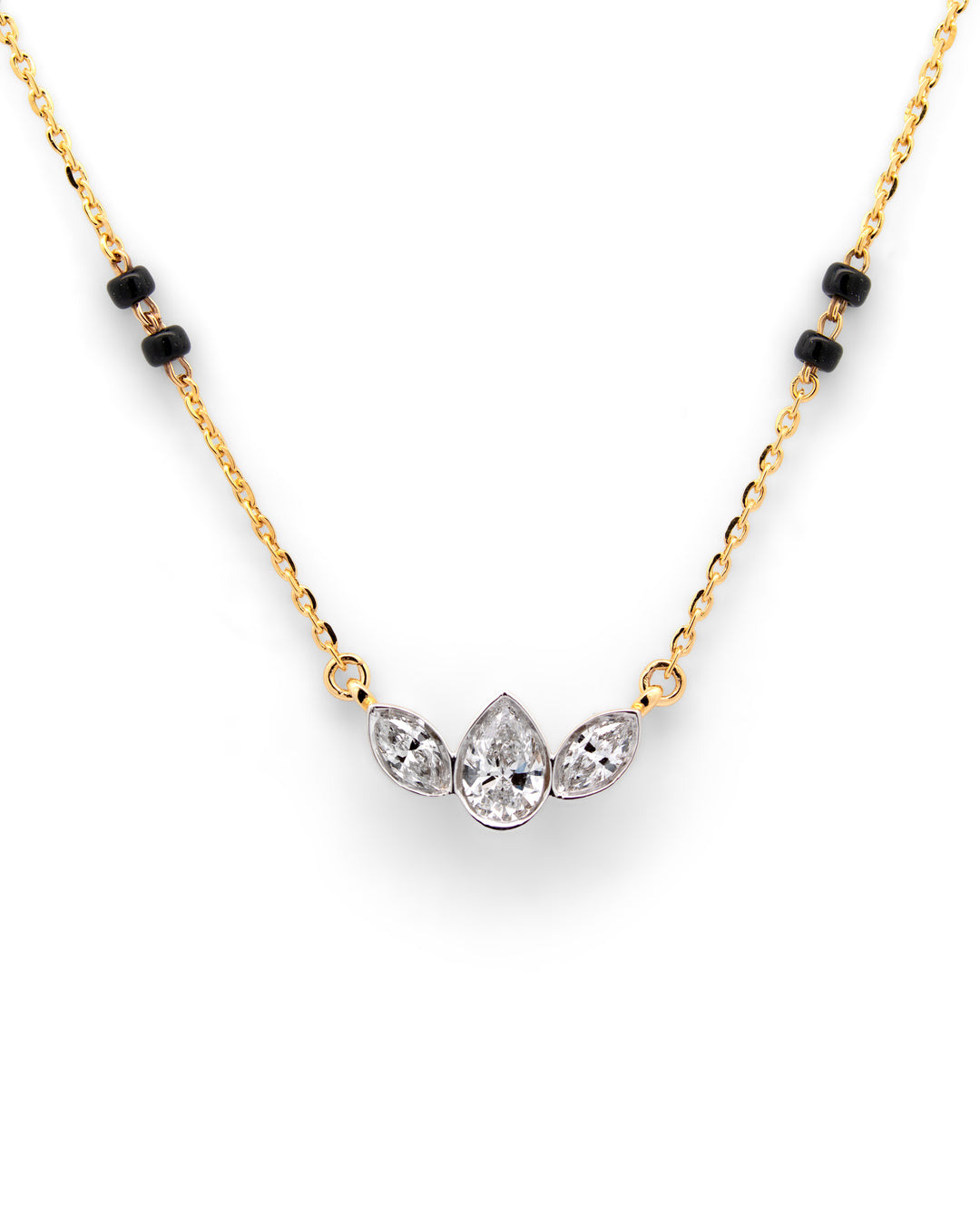Gold necklace with black beads and three clear gemstones on a white background