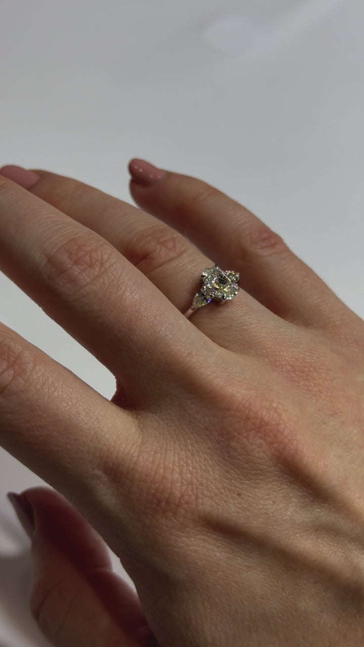 Oval and Pear Diamond Engagement Ring on body