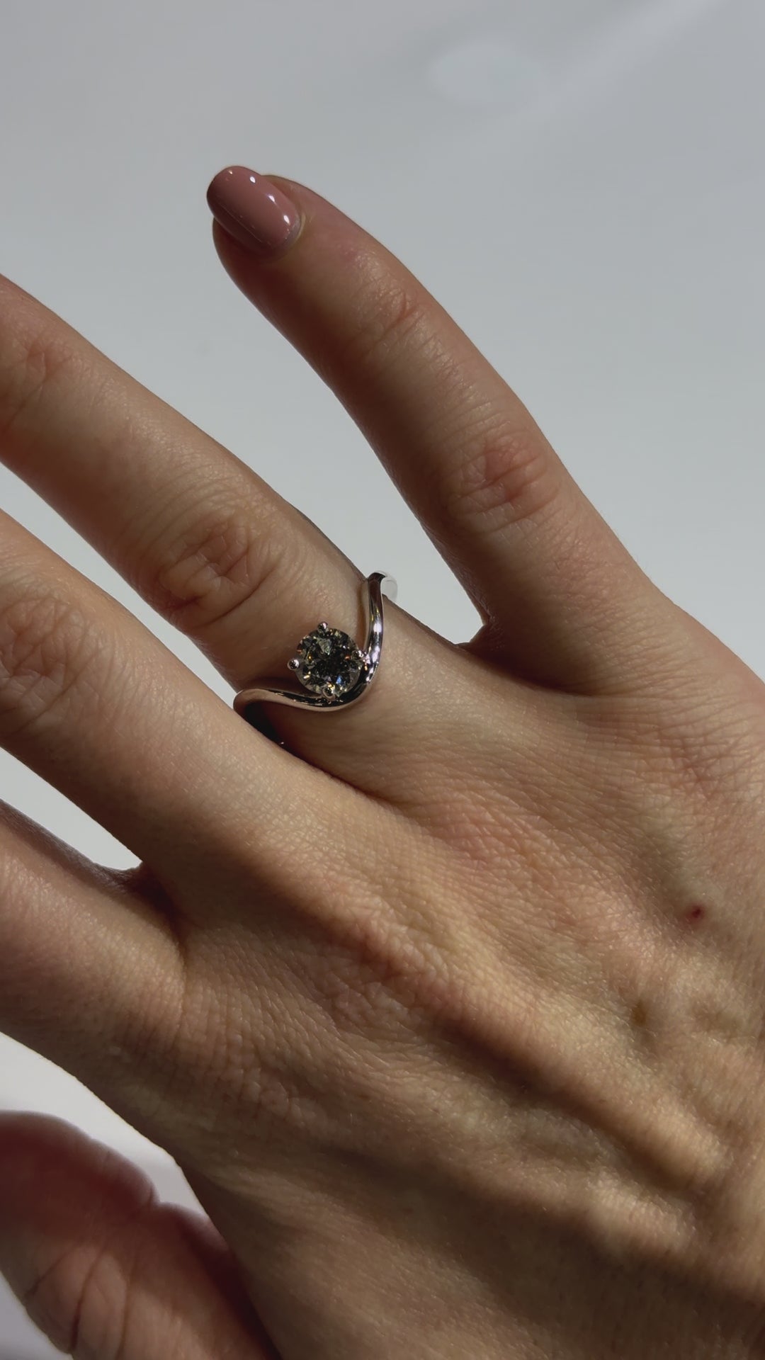 Solitaire Round Diamond Contemporary Engagement Ring on hand